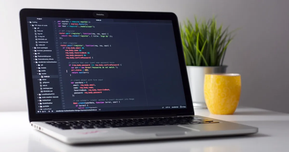 Developer maintaining code on laptop